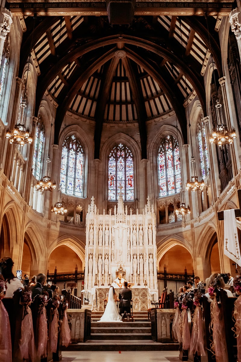 Wedding & Elopement Photographer, bride and groom say vows in large Cathedral
