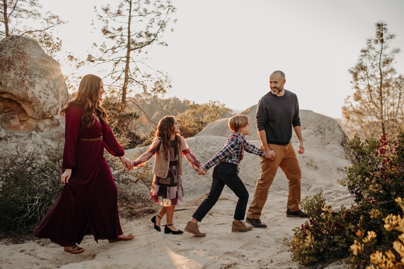 Family Photographer, a dad leads his two kids and wife through a mountain trail