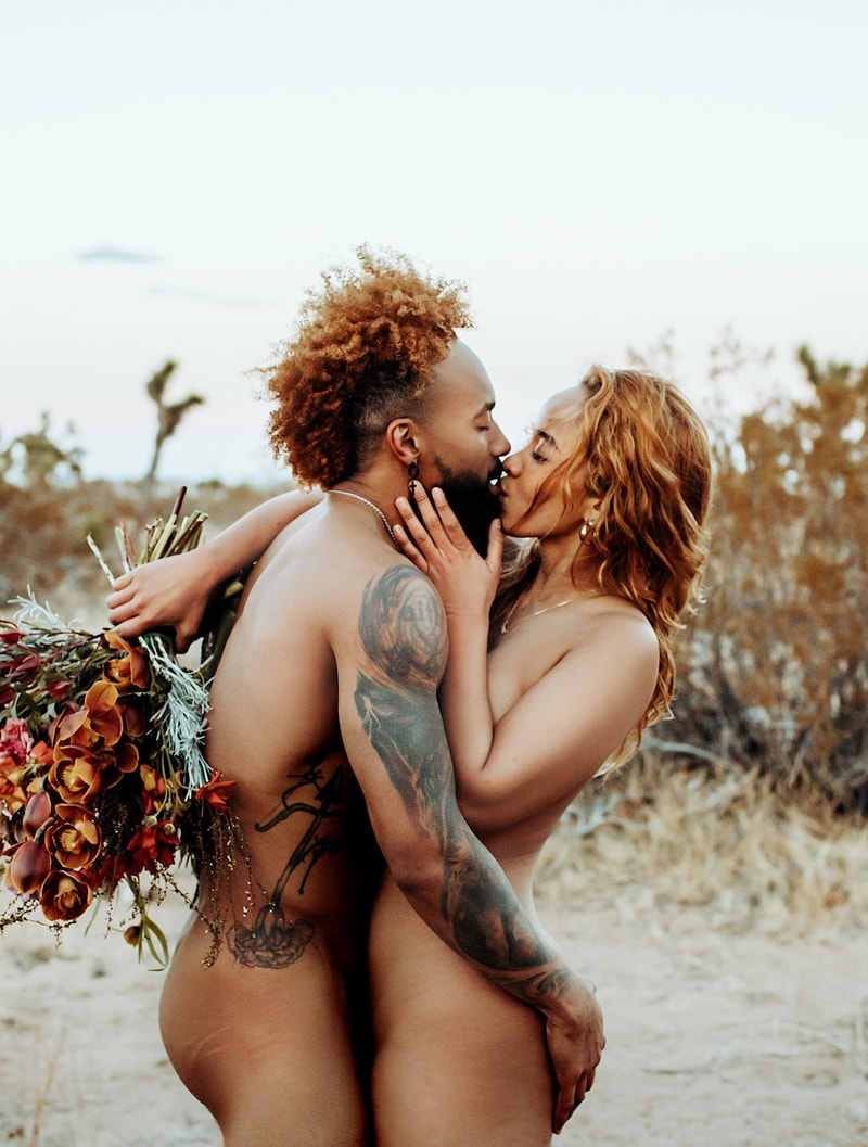 Couples Photographer, man and woman embrace nude at the beach