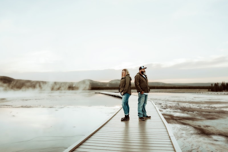 Elopement Photographer, husband and wife stand on wooden walkway in death valley