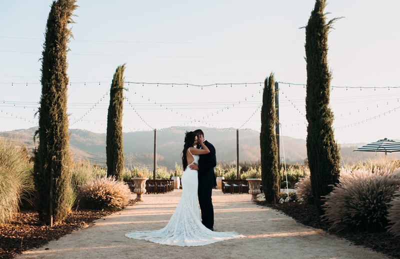 Wedding photographer, bride and groom dance outdoors