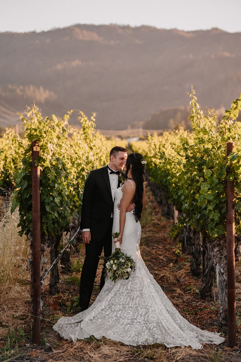elopement photographer, husband and wife kiss in a vineyard