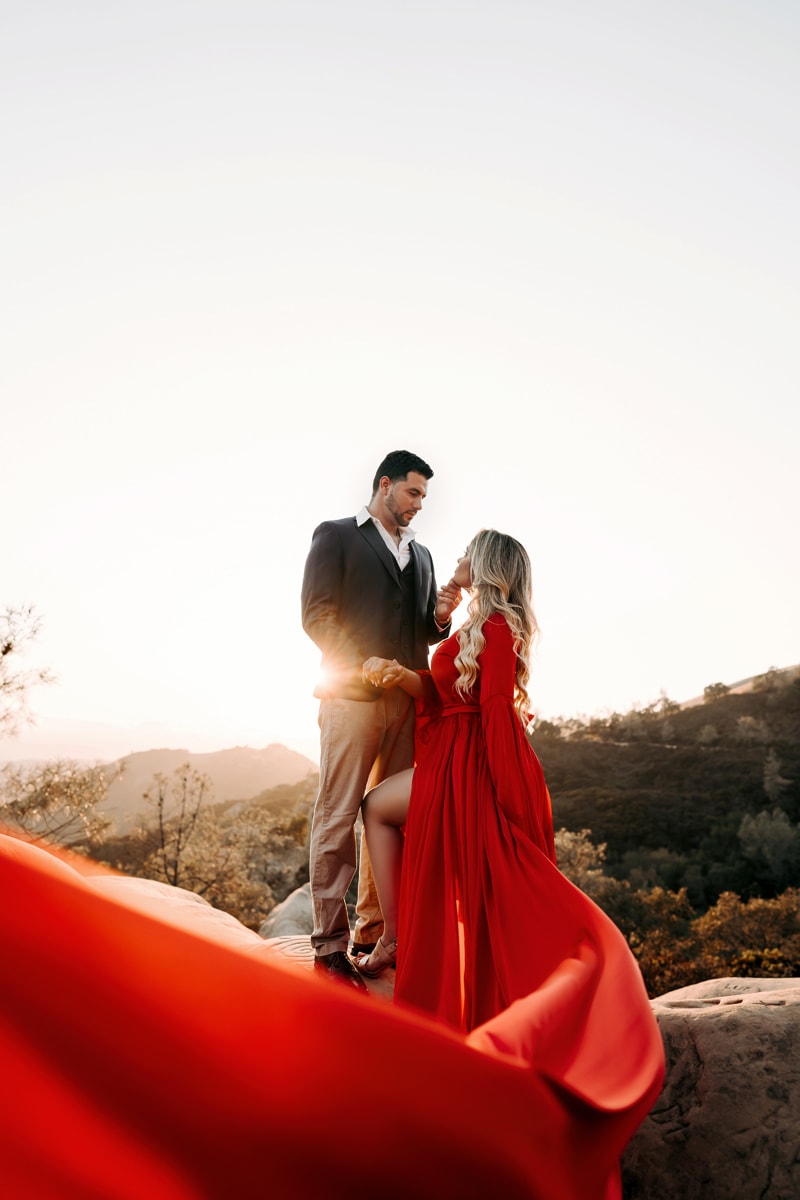 Couples Photographer, man and woman look into each other's eyes, she wears dress with long train